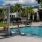a swimming pool with shaded poolside seating