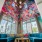 large lounge area with high ceilings, painted walls showing the bright property colors and seating